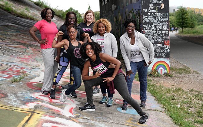 Group of women posing and showing their muscles. 