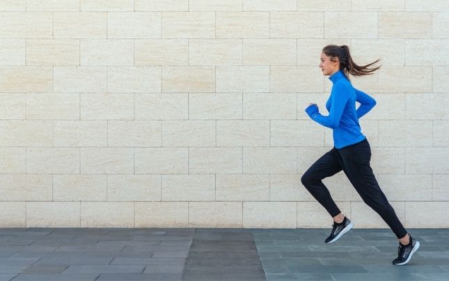Woman running on street 