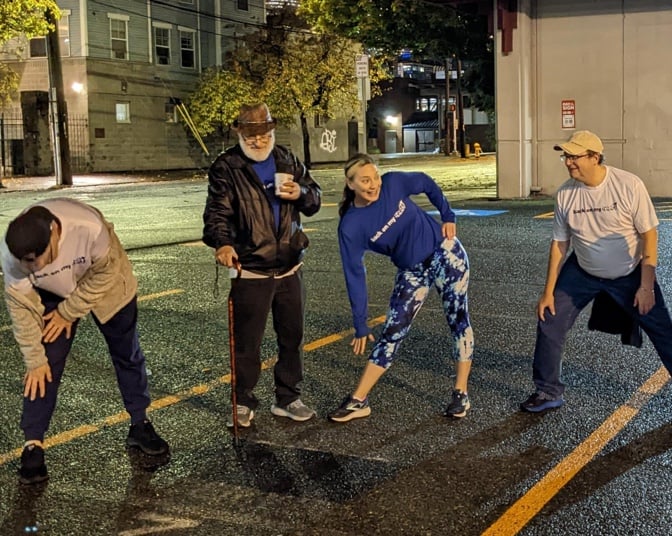Joy Wilcox, BoMF West Coast Territory Director, stretches with members at a Seattle circle up