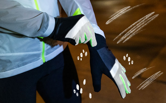 Closeup of a runner putting on Brooks Run Visible Carbonite Gloves.