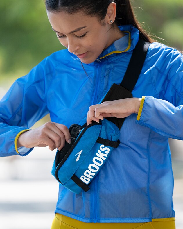 Women reaching into running waist pack