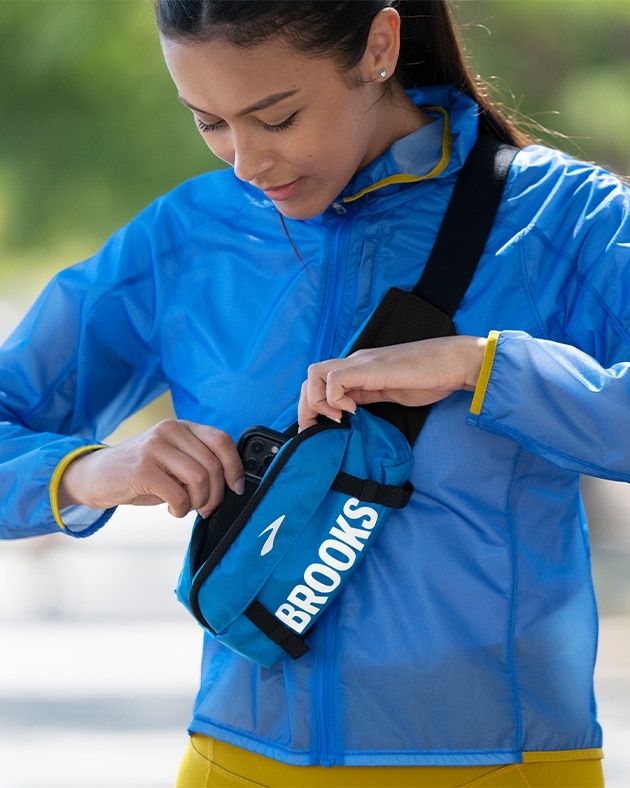 Women reaching into running waist pack