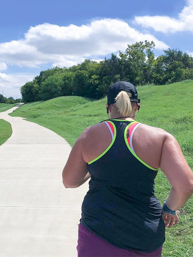 Runner going down a paved path