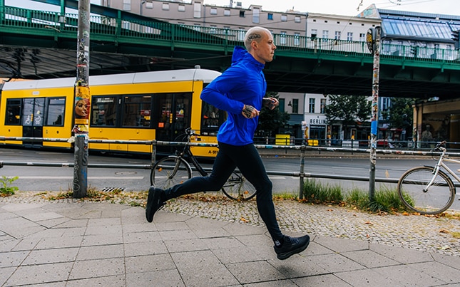 Runner in front of a brick wall