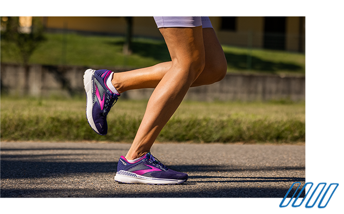 Close up photo of the legs of two runners wearing Brooks Adrenaline GTS shoes with GuideRails technology. 