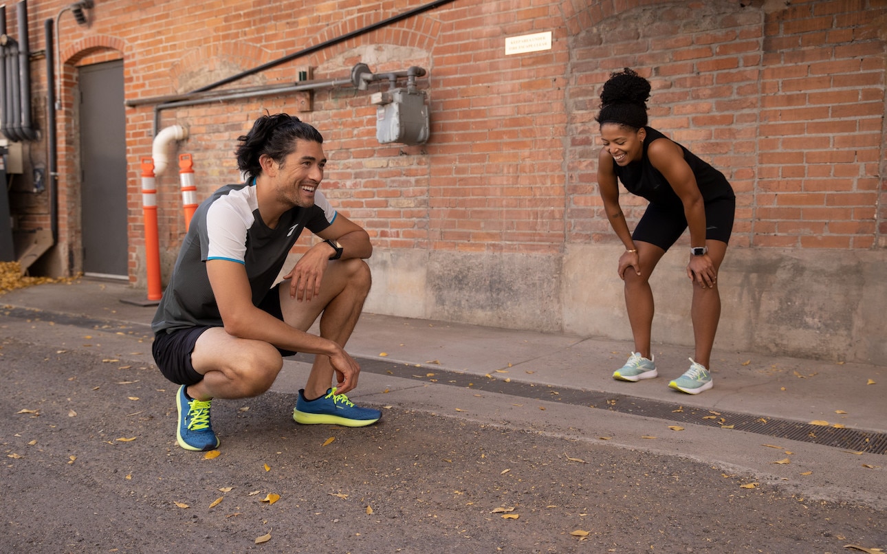 A man and a woman taking some rest on a run