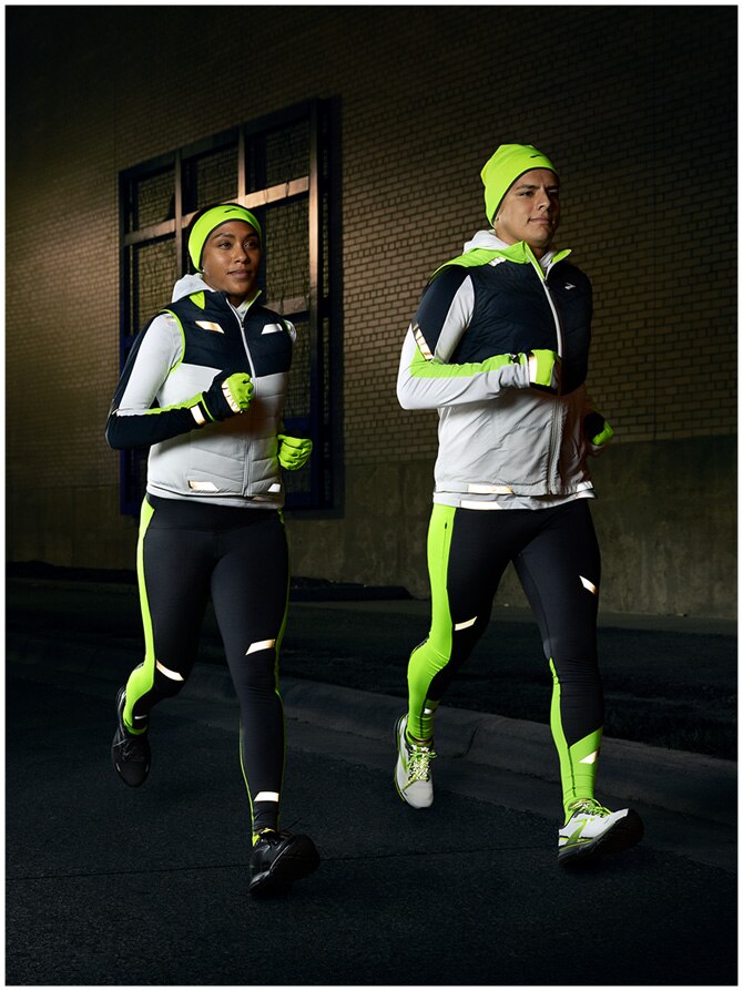 Two runners wearing the Run Visible Collection