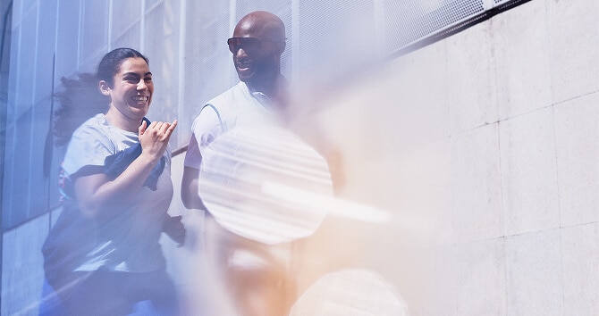 Two people running and smiling