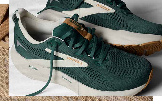 Green Brooks shoes rest on a white surface