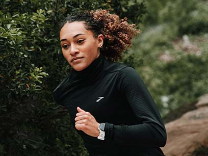 Woman running while wearing Brooks apparel