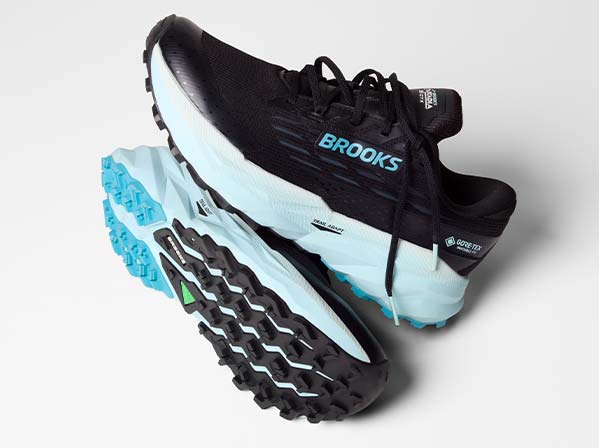 Black and blue Brooks women's shoes rest on a surface