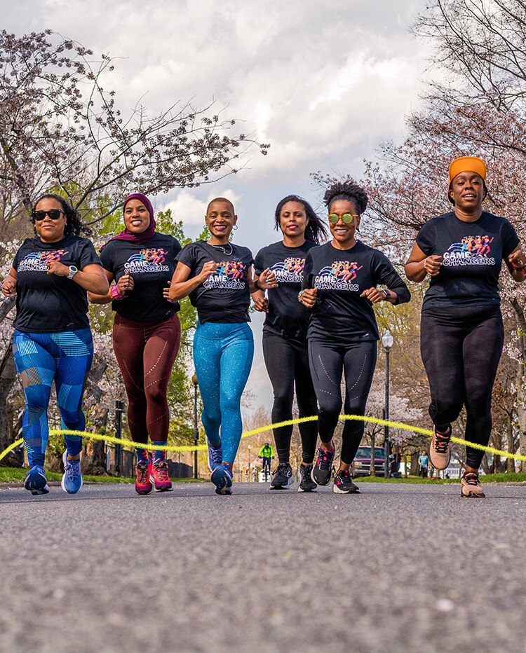 Six women running side by side