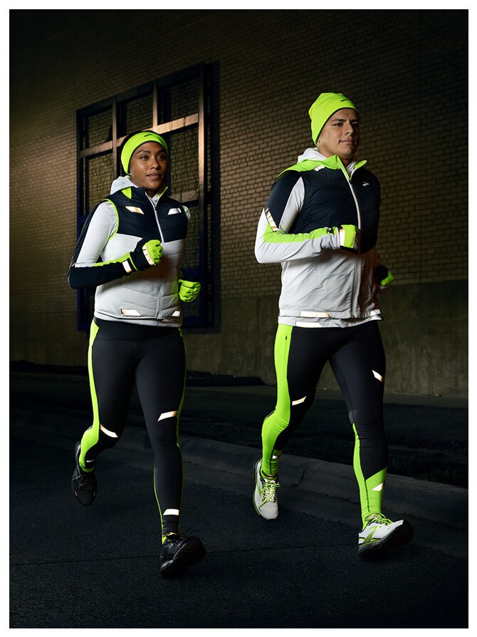 Two runners wearing the Run Visible Collection