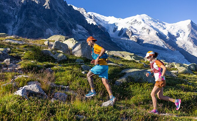 Two models running on a mountain and wearing Brooks Trail apparel and shoes