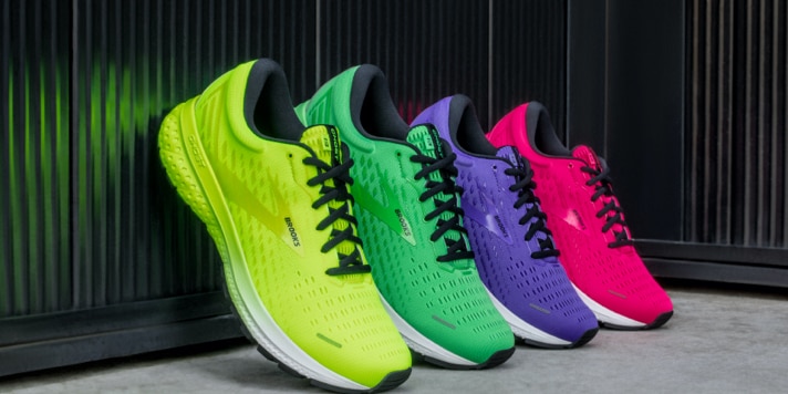 Yellow, purple, pink and green shoes lined up