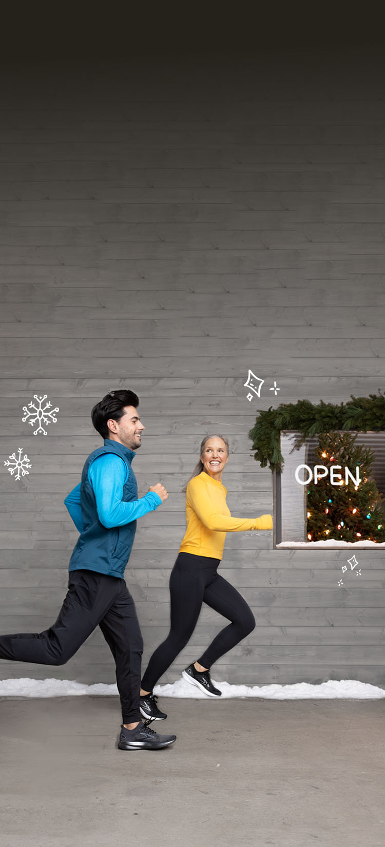 Man and woman running side by side with illustrations of snowflakes falling and a Christmas tree in the window behind them.