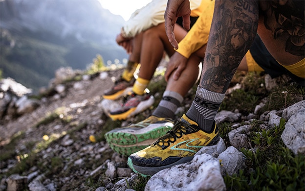 Close-up shot of a woman and a man wearing the Caldera 7 trail running shoes