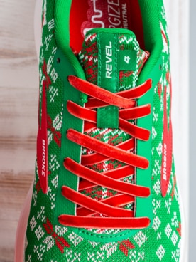 A green shoe with red laces from above