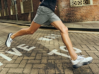Medium shot of a man running on road