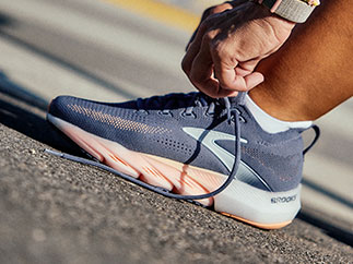 A closeup of a woman tying her shoe