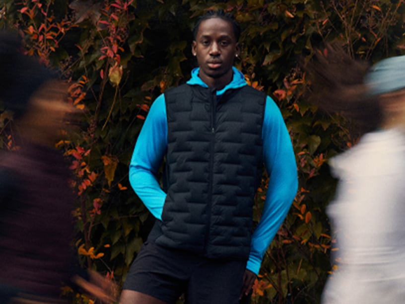 A man wearing Brooks apparel looks straight ahead