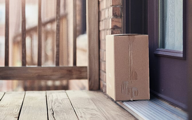 A cardboard box sits on a doorstep