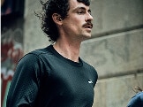 A person wearing Brooks gear looks to the side