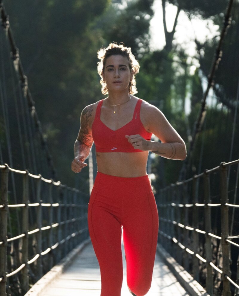 Brooks runner wearing red apparel and bra