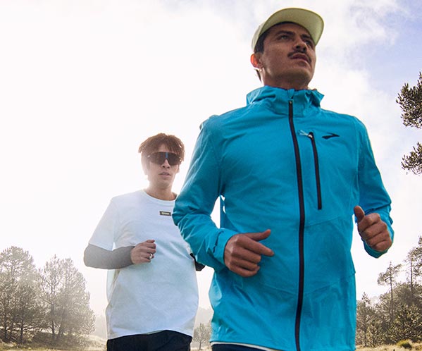 A person wearing men's Brooks apparel while running outside