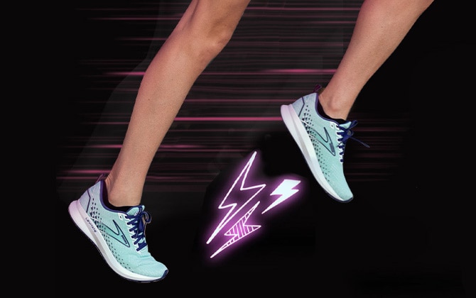 The legs of a woman running in the Levitate 5. Neon pink lightning bolts shoot out from the bottom of one of the shoes. Next to the legs is a white QR code with the word “scan” and an arrow pointing to the code.