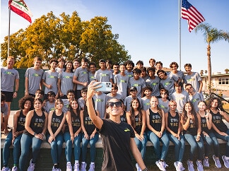 A group of people pose to take a selfie