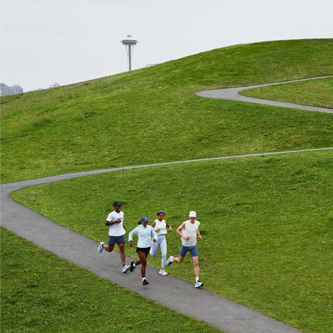 brooks runners running in a green field
