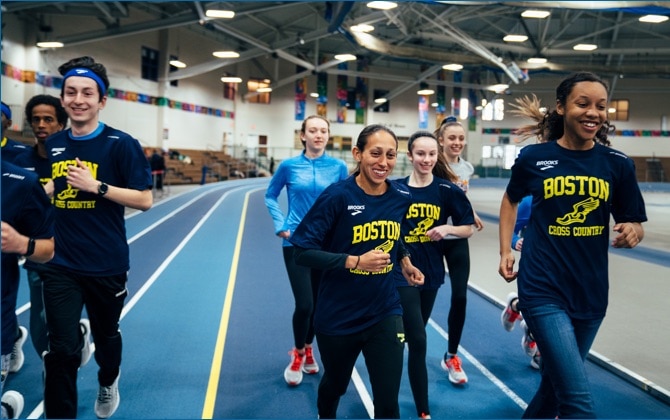 Des Linden on running track with young students