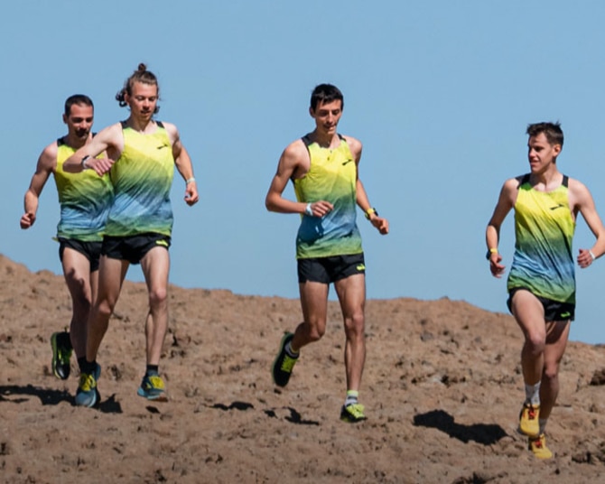 Trail team running up rocky terrain.