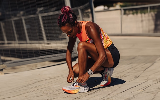 Athlete tying her Brooks shoes