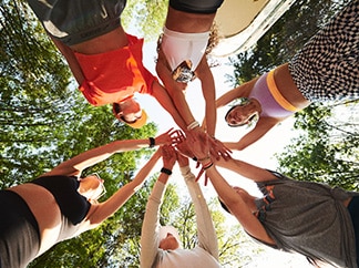 Runners putting their hands together