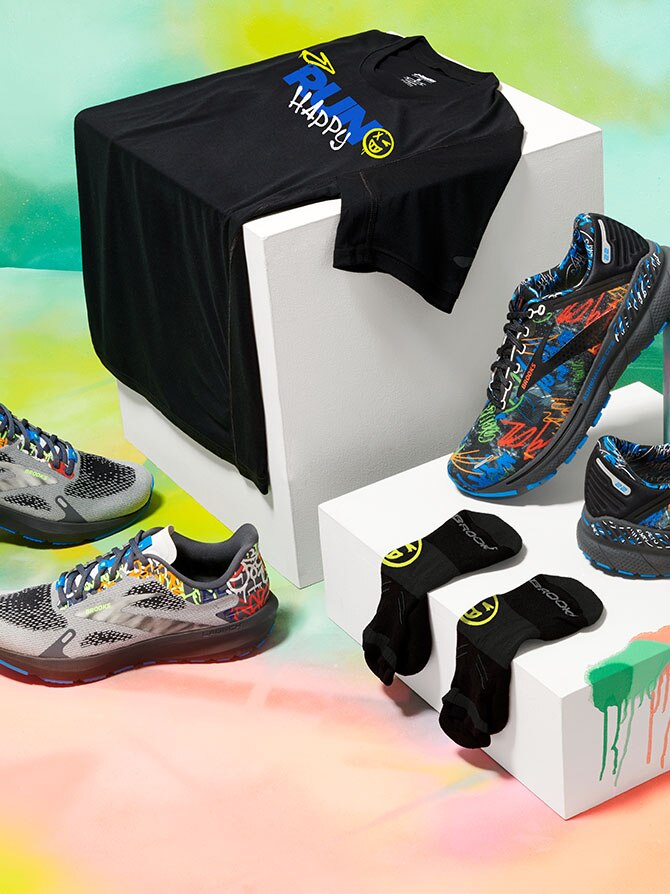 Shoes, socks and shirt propped up on boxes with colorful background