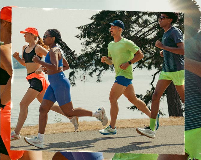People in bright clothing run next to a body of water