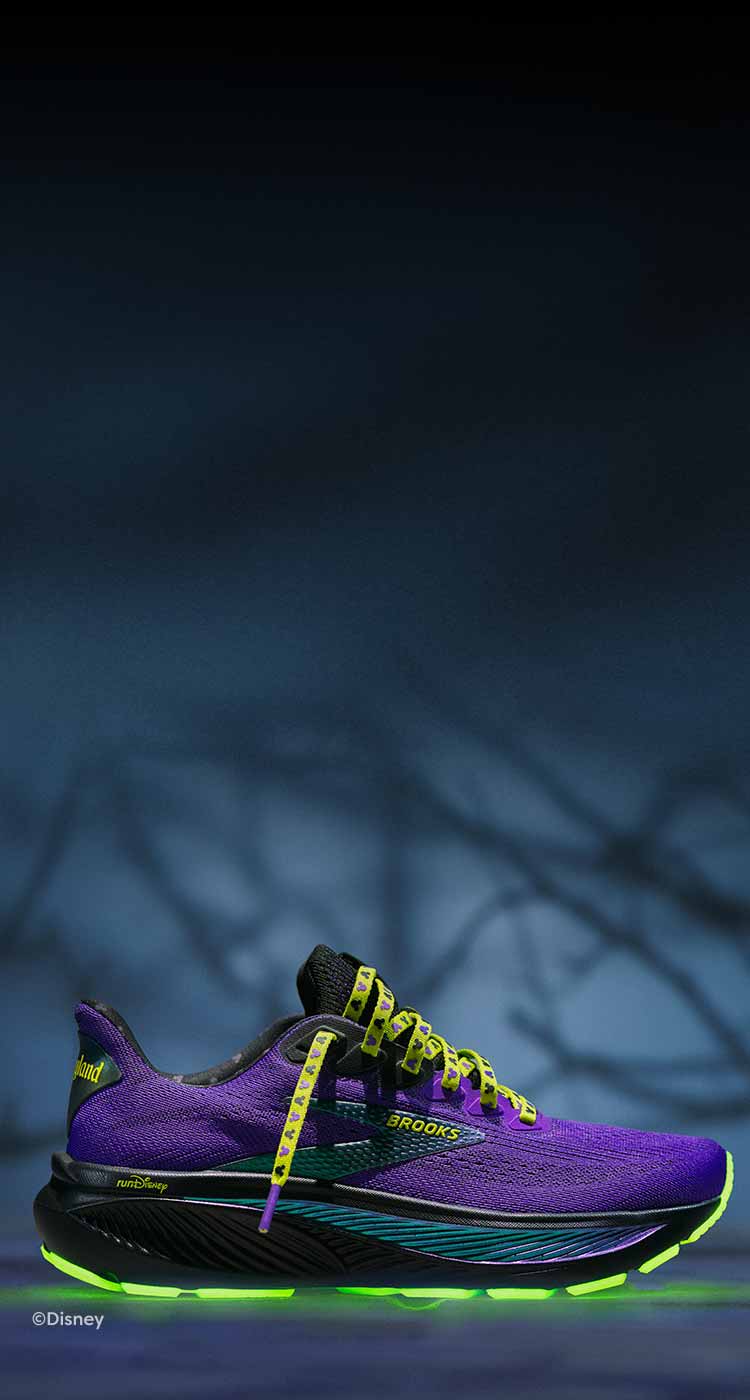 Purple and green shoe sits against a dark background.