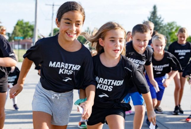 Young kids running with Brooks branded t-shirts