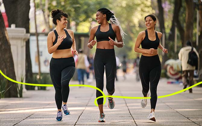 Three runners side by side on concrete path