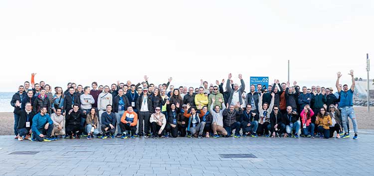A group of people pose for a picture outside
