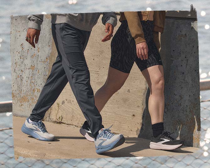 Two people walking in the sunshine