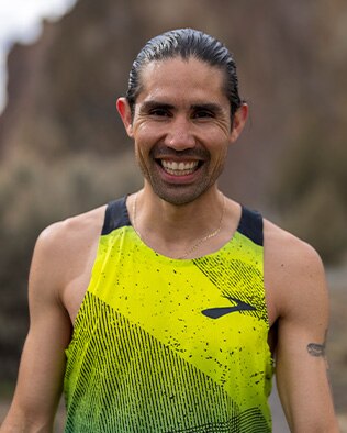 Man smiling with yellow tank top