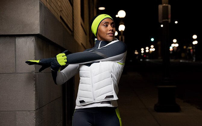 Runner wearing Run Visible apparel stretches
