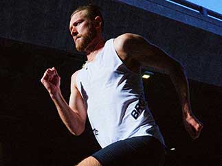 A man running outside wearing Brooks apparel