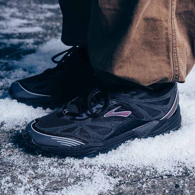 Person wearing the Cascadia 1 on a snowy sidewalk