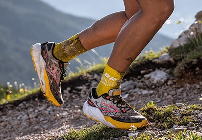 A runner in stride on a dirt surface