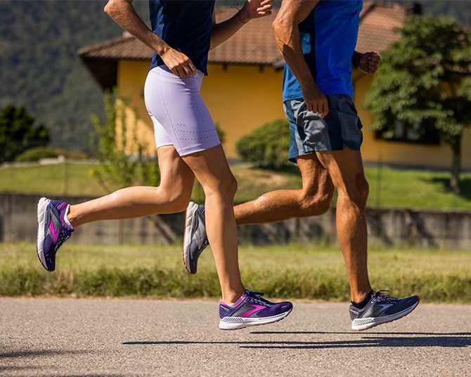 Side view of two runners on a sunny day