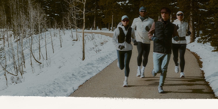 Brooks runners enjoying a winter run on a scenic mountain trail.